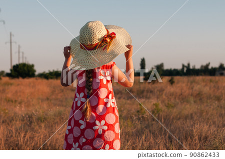 Child girl in straw hat dress in wheat field. Smiling kid in sunglasses sunset countryside. Cottagecore style aesthetic. Child girl in straw hat dress in wheat field. Smiling kid in sunglasses sunset countryside. Cottagecore style aesthetic. 90862433