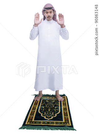 Muslim man with keffiyeh with agal in praying position (salat) on the prayer rug 90863148
