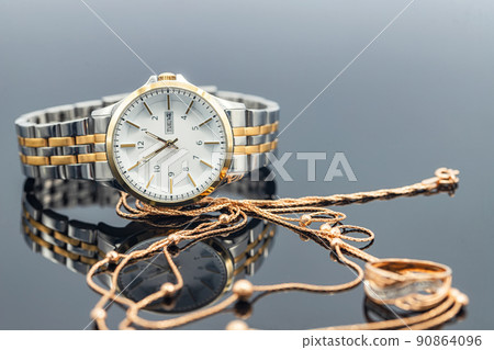 Accessories and jewelry for a fashionable girl : gold ring, necklace and original wristwatch 90864096