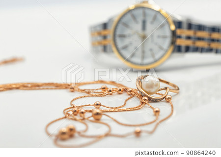 Accessories and jewelry for a fashionable girl : gold ring, necklace and original wristwatch 90864240
