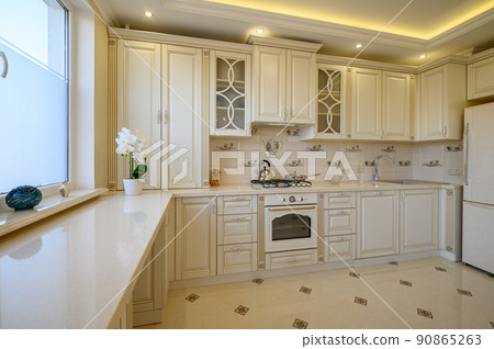 Classic white and beige large luxurious kitchen in studio apartment 90865263