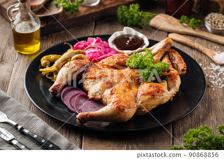 chicken tobacco Portion of chicken tobacco dish with sauce - Stock Photo [90868856]