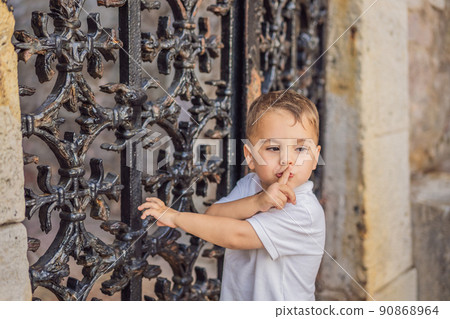 Adorable caucasian kid asking to be quiet with finger on lips. silence and secret concept Adorable caucasian kid asking to be quiet with finger on lips. silence and secret concept 90868964