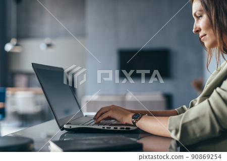 Business woman working with laptop at her desk 90869254