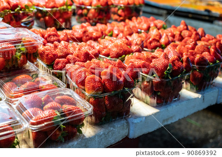 Top view of strawberry in the baskets, ready for sell in the fruit store. Concept of fresh fruit and diet. Spring time. Natural fruit strawberry background. 90869392