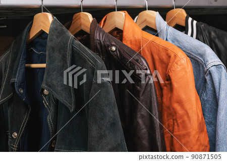 Various vintage jackets on clothing rack in second hand store 90871505