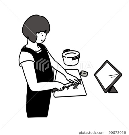A woman cooking while looking at a tablet 90872036