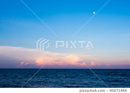 Clouds and moon in sunset sky over sea 90872466