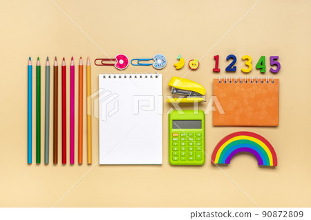Frame from school and office supplies Paper clips, pens, calculator, sharpener, notepad, stapler isolated on beige background Flat lay Top view Back to school, education concept Mock up Copy space. Frame from school and office supplies Paper clips, pens, calculator, sharpener, notepad, stapler isolated on beige background Flat lay Top view Back to school, education concept Mock up Copy space. 90872809