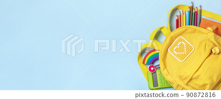 Back to school, education concept Yellow backpack with school supplies - notebook, pens, eraser rainbow, numbers isolated on blue background Top view Copy space Flat lay composition Banner. 90872816