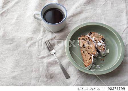Sliced Stollen on a plate of coffee and khaki Sliced Stollen on a plate of coffee and khaki 90873199