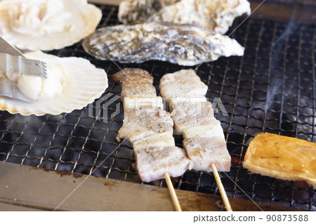 Delicious charcoal grill, pork skewers, salmon harass, scallops, grilled oysters Delicious charcoal grill, pork skewers, salmon harass, scallops, grilled oysters 90873588