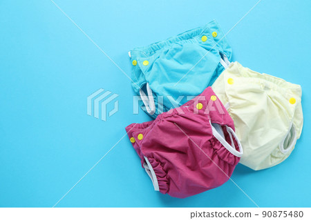 Reusable diapers on blue background, close up 90875480