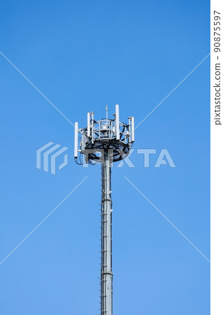 Silver radio tower towering in the blue sky Silver radio tower towering in the blue sky 90875597