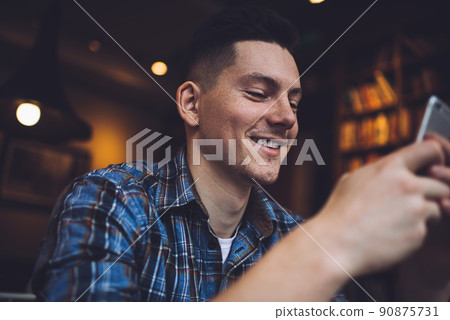 Cheerful generation Z checking received sms message on modern smartphone technology 90875731