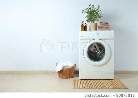 Concept of housework with washing machine against white wall Concept of housework with washing machine against white wall 90875818