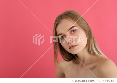 Beautiful model girl with makeup on pink background Beautiful model girl with makeup on pink background 90875938