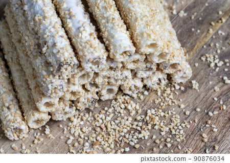 waffle tube with chocolate filling and crushed peanuts waffle tube with chocolate filling and crushed peanuts 90876034