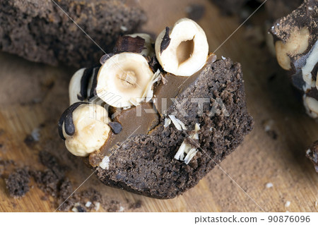 multicomponent cake made of caramel and nuts in chocolate 90876096