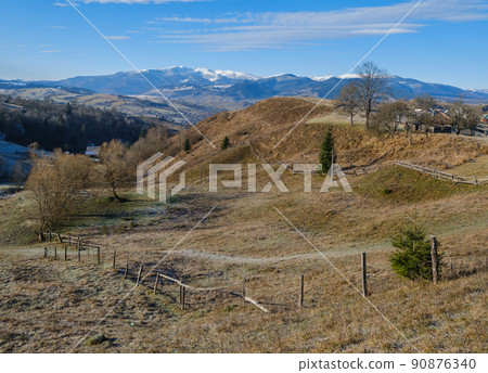 Last good weather days in autumn mountain countryside morning peaceful picturesque scene. Ukrainian Carpathians mountains in far. 90876340
