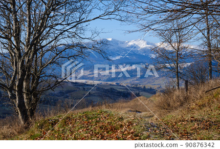 Last good weather days in autumn mountain countryside morning peaceful picturesque scene. Ukrainian Carpathians mountains in far. 90876342