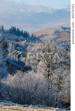 Winter coming. Last days of autumn, morning in mountain countryside peaceful picturesque hoarfrosted scene.  Ukraine, Carpathian mountains. 90876362