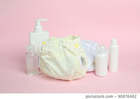 Concept of baby clothes with reusable diapers on pink background 90876482