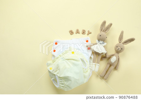 Concept of baby clothes with reusable diapers on light background Concept of baby clothes with reusable diapers on light background 90876488