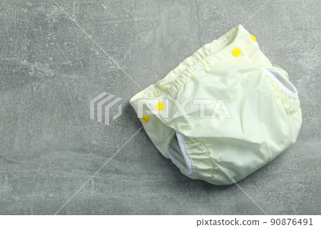 Reusable diapers on gray textured background, close up Reusable diapers on gray textured background, close up 90876491