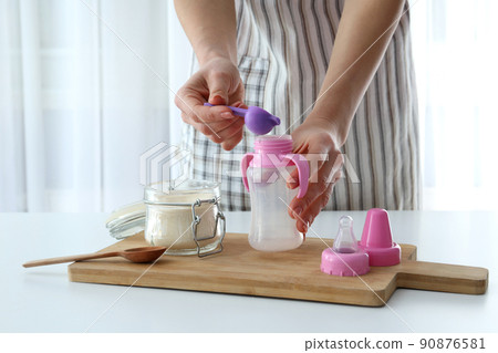 Concept of baby food with powdered milk Concept of baby food with powdered milk 90876581