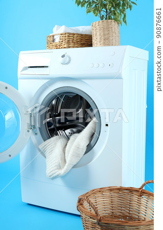 Concept of housework with washing machine on blue background 90876661
