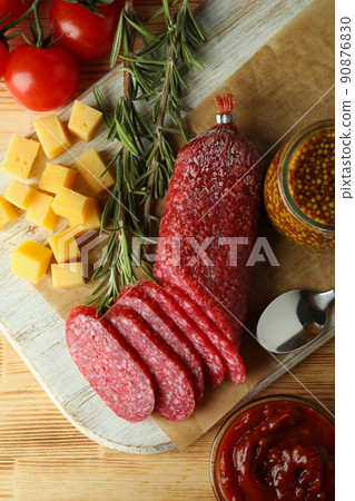 Concept of tasty food with salami sausage on mint background 90876830