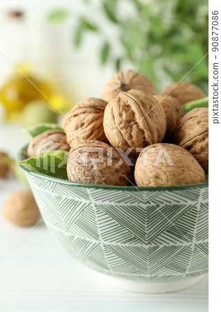 Concept of healthy food with walnuts on white wooden background Concept of healthy food with walnuts on white wooden background 90877086
