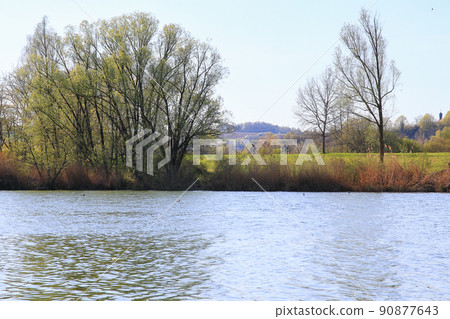 Regensburg, Germany, people are riding the bike on a rural road at sunset along Danube river in Regensburg, Germany, Europe. 90877643