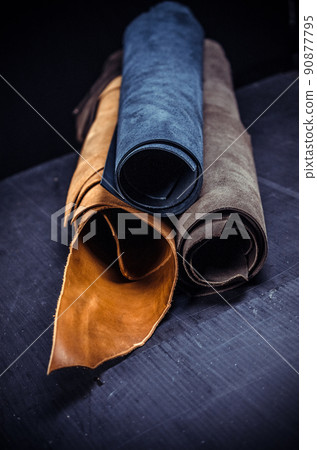 three large roll of colored skin on the table in the workshop 90877795