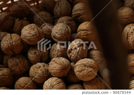 Walnuts with in wicker basket, close up Walnuts with in wicker basket, close up 90878544