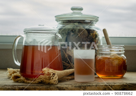 Refreshing with Chinese herbal tea (Jub Lieng) served with honey on old wooden table with city view. 90878662