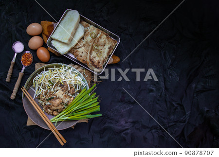 Stir fried soft turnip cake or Fried radish cake (chai tow kway) with bean sprout and chives in ceramic plate. Stir fried soft turnip cake or Fried radish cake (chai tow kway) with bean sprout and chives in ceramic plate. 90878707