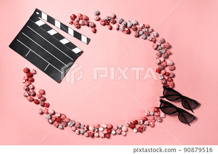Movie clapper, pop corn and 3d glasses in a pink background. Flat lay. Cinema party concept. 90879516