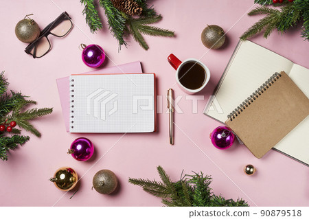 Christmas home office desk with notebook, cup of coffee and christmas gold and pink decorations. Flat lay. Top view with space for text. 90879518