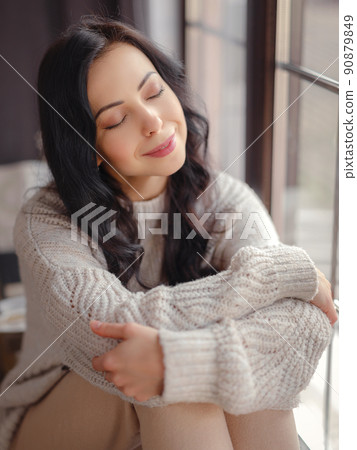 Beautiful young woman near window at home Beautiful young woman near window at home 90879849