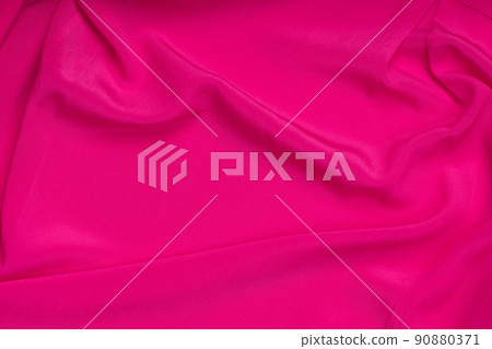 Wavy folds of pink silk texture satin velvet material or luxurious pink silk as background, folds of pink silky fabric. 90880371