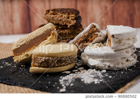 Three different types of the classic Argentinean alfajores filled with dulce de leche. Traditional food. 90880502