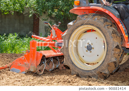 Cultivator for a mini-tractor for loosening the soil. Agricultural work. Excavation. Close-up 90881414