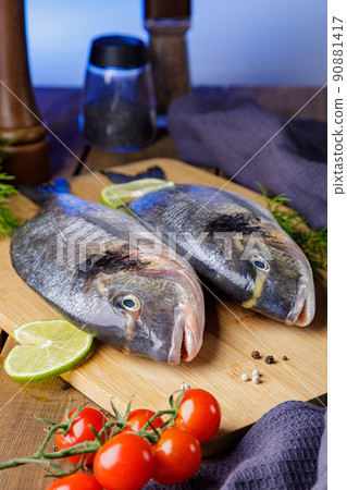 Raw peeled dorado fish with cooking ingredients. Fresh fish on a wooden background 90881417