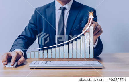 Businessman pointing to virtual investment bar and line graph on wooden table as business strategy and stock value investor concept. Businessman pointing to virtual investment bar and line graph on wooden table as business strategy and stock value investor concept. 90886754