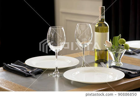the table in the restaurant is served with white dishes 90886850