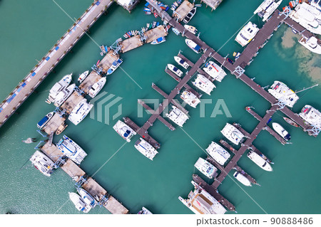 Aerial View Top down Drone shot of Yacht and sailboat parking in marina Transportation and travel background Beautiful sea in summer season Aerial View Top down Drone shot of Yacht and sailboat parking in marina Transportation and travel background Beautiful sea in summer season 90888486