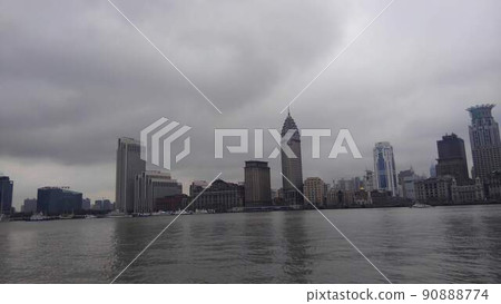 Large and small boats floating on the river flowing against the backdrop of dark rain clouds and old and new buildings in Shanghai Large and small boats floating on the river flowing against the backdrop of dark rain clouds and old and new buildings in Shanghai 90888774