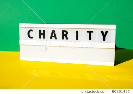 Lightbox with text CHARITY. Motivational Words Quotes Concept. Colorful yellow background. Minimalistic creative concept. Lightbox with text CHARITY. Motivational Words Quotes Concept. Colorful yellow background. Minimalistic creative concept. 90891435